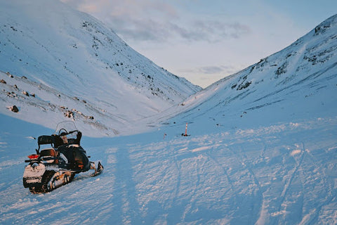 Snowmobile sits in a snowy vally. Heat Holders­® Base Layers