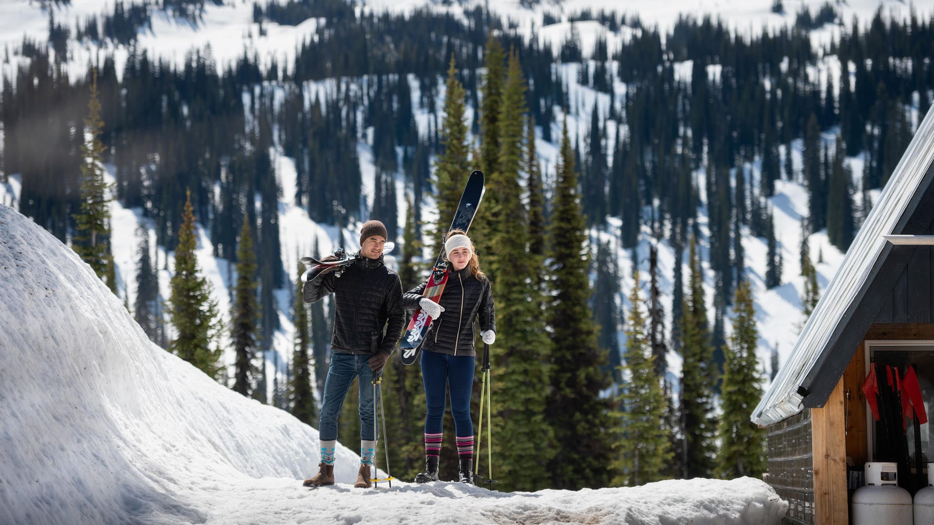 Couple going skiing in the mountains wearing Heat Holders apparel, socks and accessories