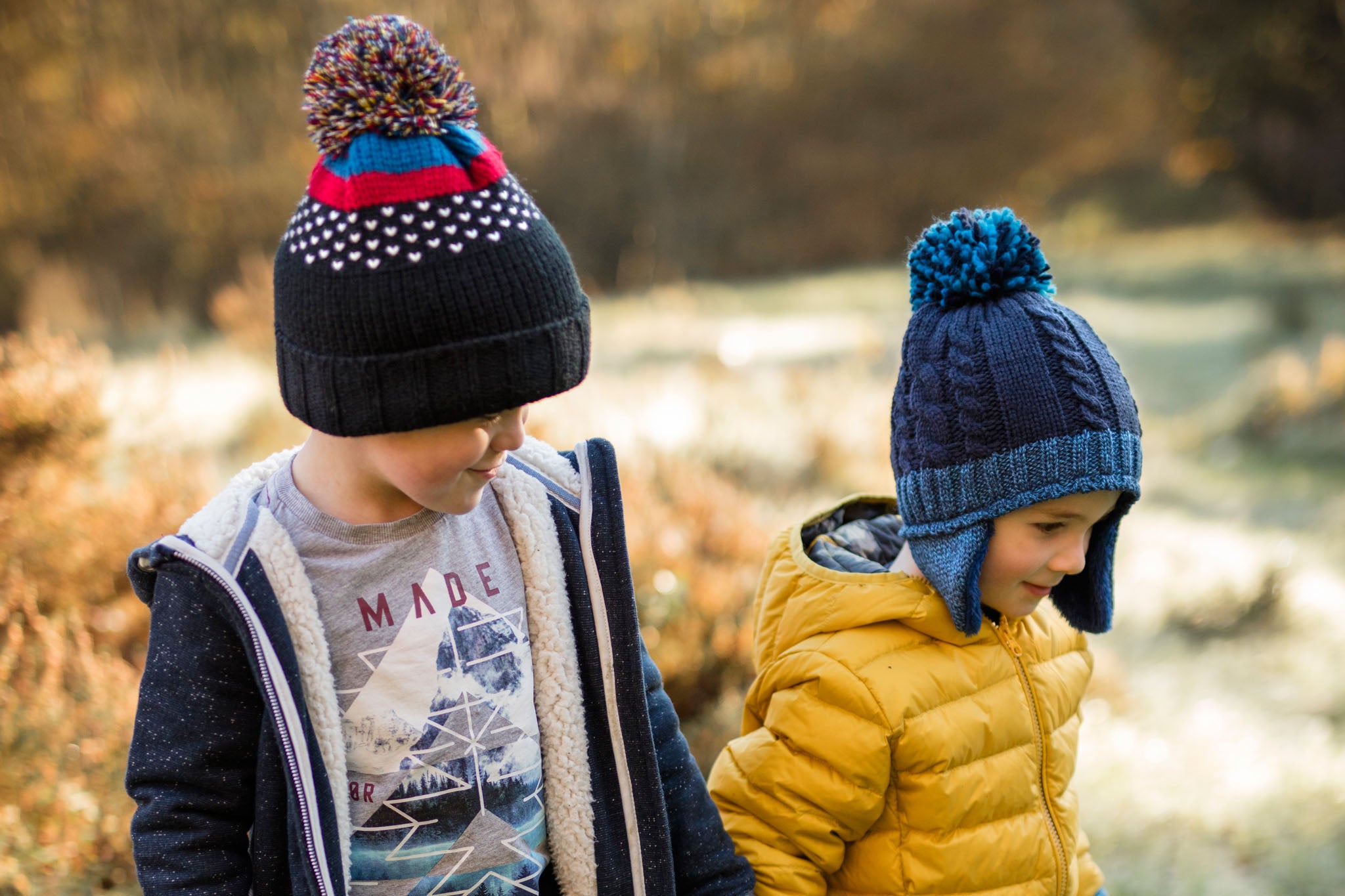 Two children wearing Heat Holders® knitted hats