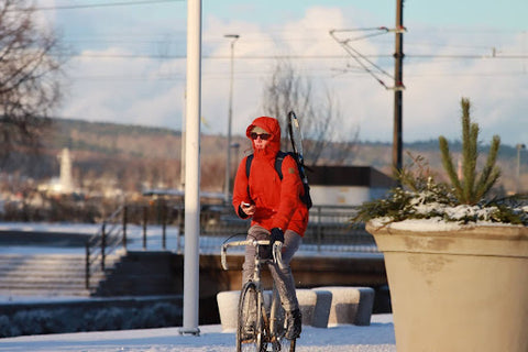 A man riding a bike in the cold. | Heat Holders®