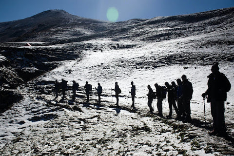 a group of hikers on a mountain in winter. | Heat Holders®
