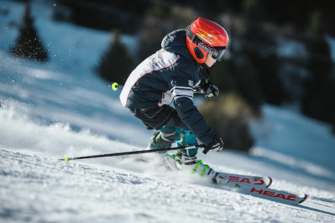 Young skier going down a mountain