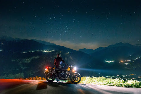 Man on motorcycle overlooking the mountains