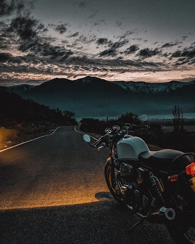 Parked motorcycle in front of mountains