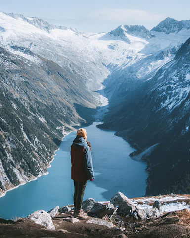 Woman overlooknig a beautiful lake in the mountains