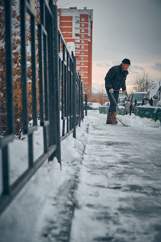 Man shovels sidewalk. | Heat Holders®
