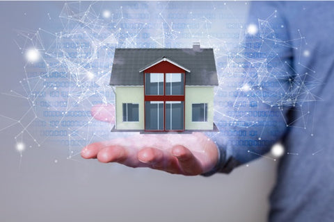 Photo of a human hand with a diagram and house