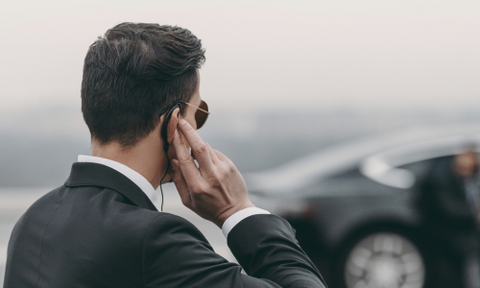 FBI agent listening to radio on an earpiece in ear