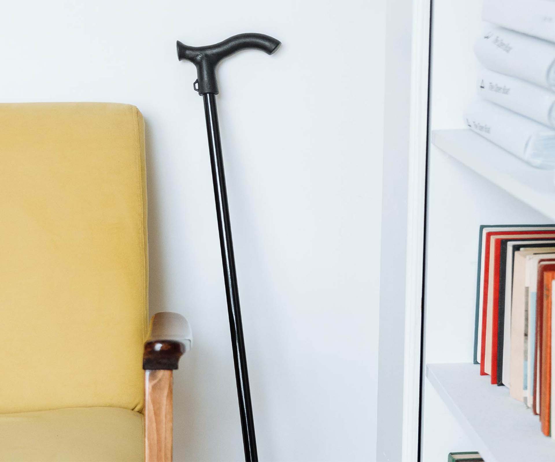 A cane leaning against a wall in a living room