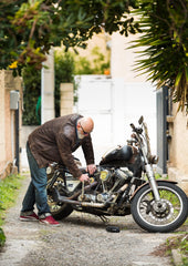 Man checking the battery on his motorcycle