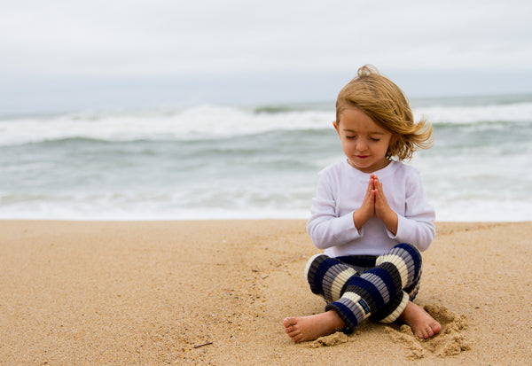 girl on a beach meditating