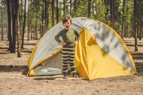 A kid camping in Ella's Wool Tubes