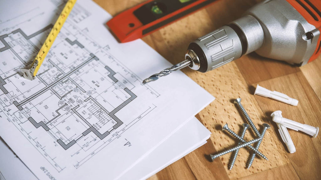 Celebrating the Joy of Work Through the Mighty Pen - A Drill On A Piece Of Paper Next To Screws And A Ruler | EndlessPens