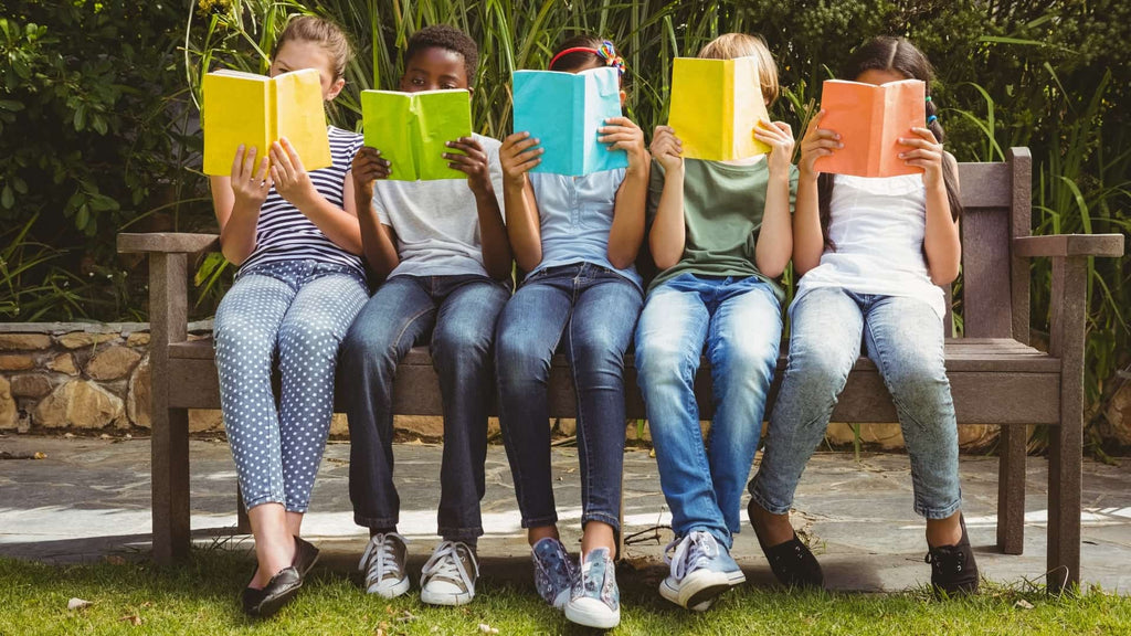 A Symphony Of Pages - A Group Of Children Sitting On A Bench While Reading Books | EndlessPens