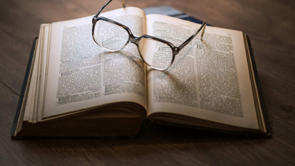 Eloquent Echoes: EndlessPens Celebrates Writers, Part IX - Glasses on Top of an Open Book