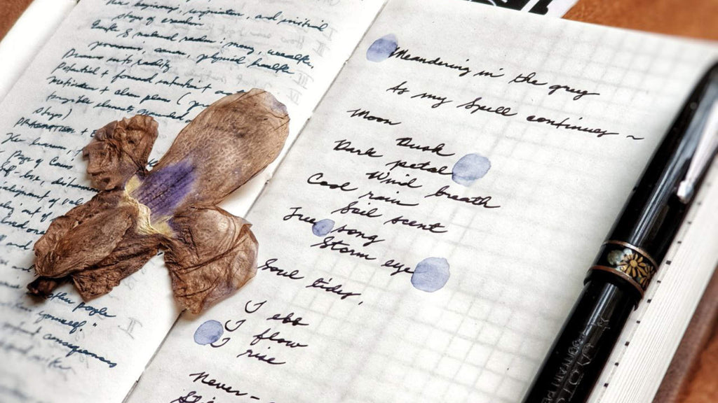 Weaving Meaning Into Words - Dried Flower On Top Of Notebook