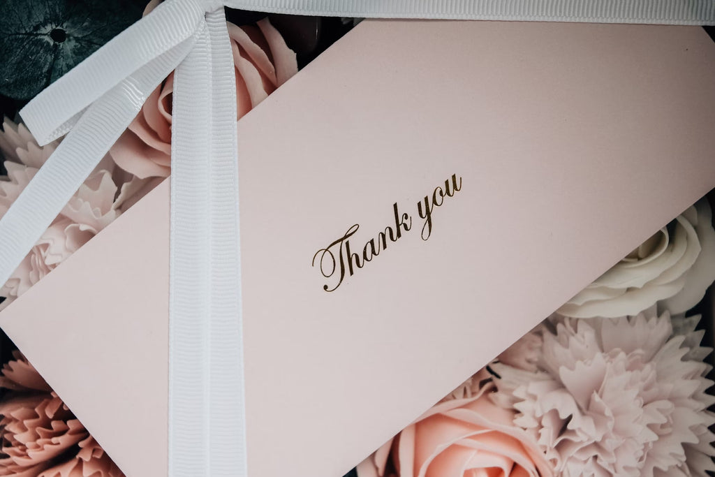 The Gift of Gratitude - A Pink Card With A White Ribbon And A Bow On A Bouquet Of Flowers | EndlessPens