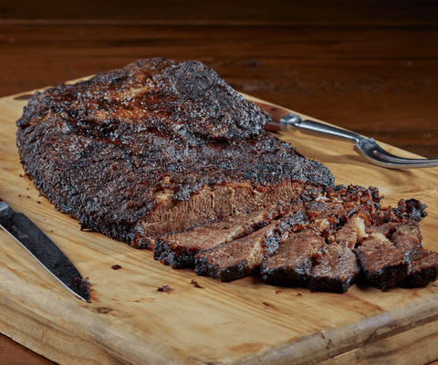 Cooked Brisket Recipe, sliced and spread on a cutting board