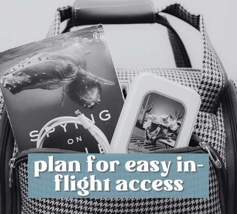Book, lavender travel tin and iphone charger sticking out of carry on suitcase with the words "plan for easy in-flight access" written over top