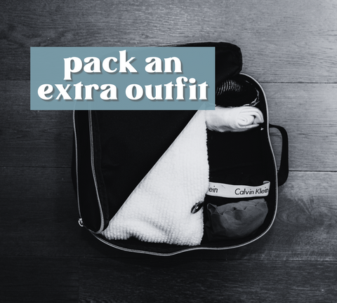 packing cube with clothing inside, half un zipped with words "pack an extra outfit" written over top.