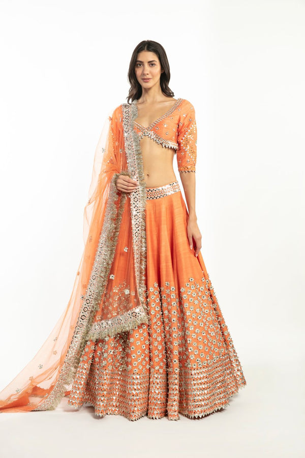 Photo of ombre gold and orange and peach lehenga with metallic foil blouse  and ombre sunset