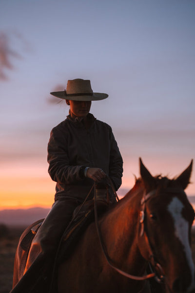 Ranch apprentice Anja and her horse Robbie at sundown. Photo by Wes Walker.