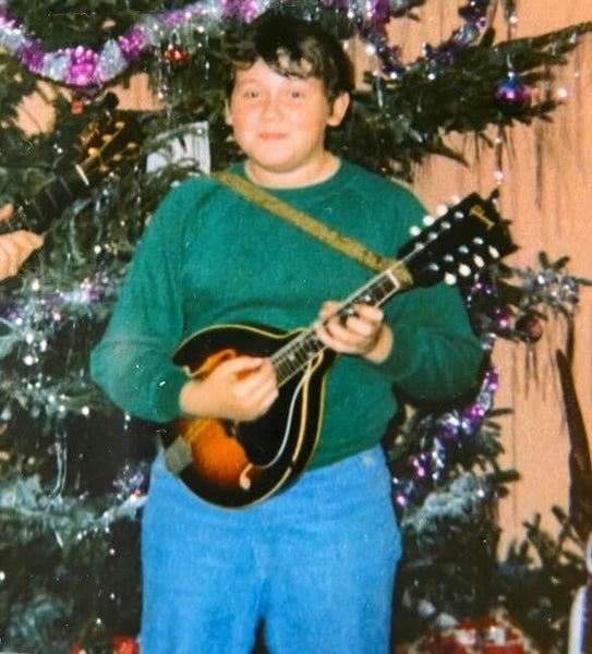 Dan as a young boy in 1975 playing his mandolin. Mandolin was his first instrument, but banjo was his favorite. Photo courtesy of Dan Tyminski.