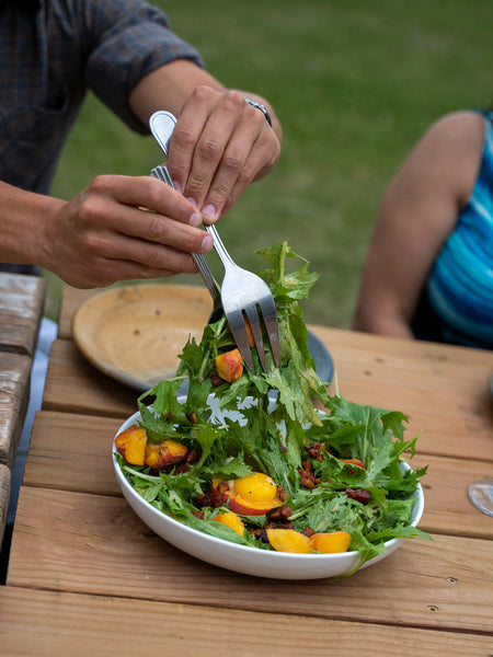 A salad of mizuna greens from the garden, with lardon, apricot, and egg yolk. Photo by Madeline Jorden.