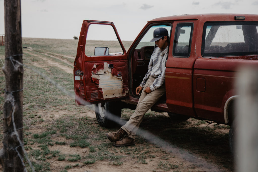 Ranch intern Brandon taking a break after checking how hot the electric fence is on July 27, 2018.