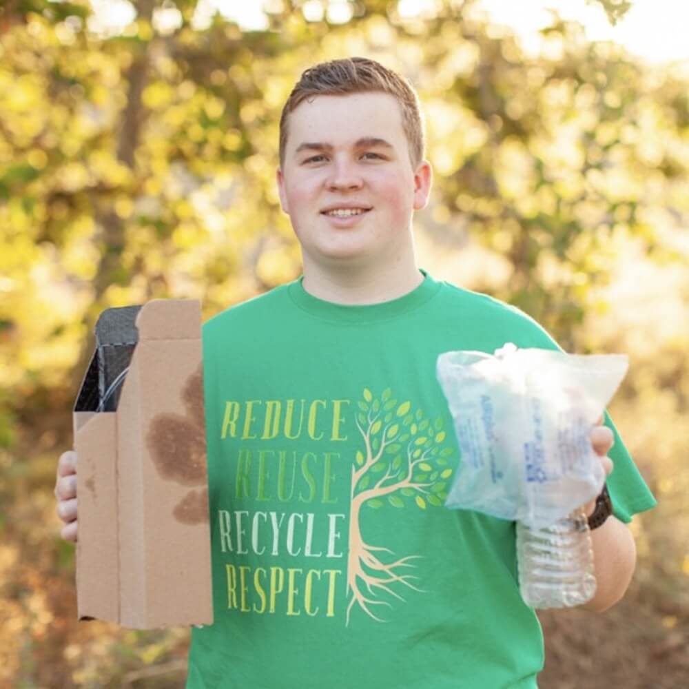 Close portrait of Charles Connelly wearing a Reduce, Reuse, Recycle green T-shirt