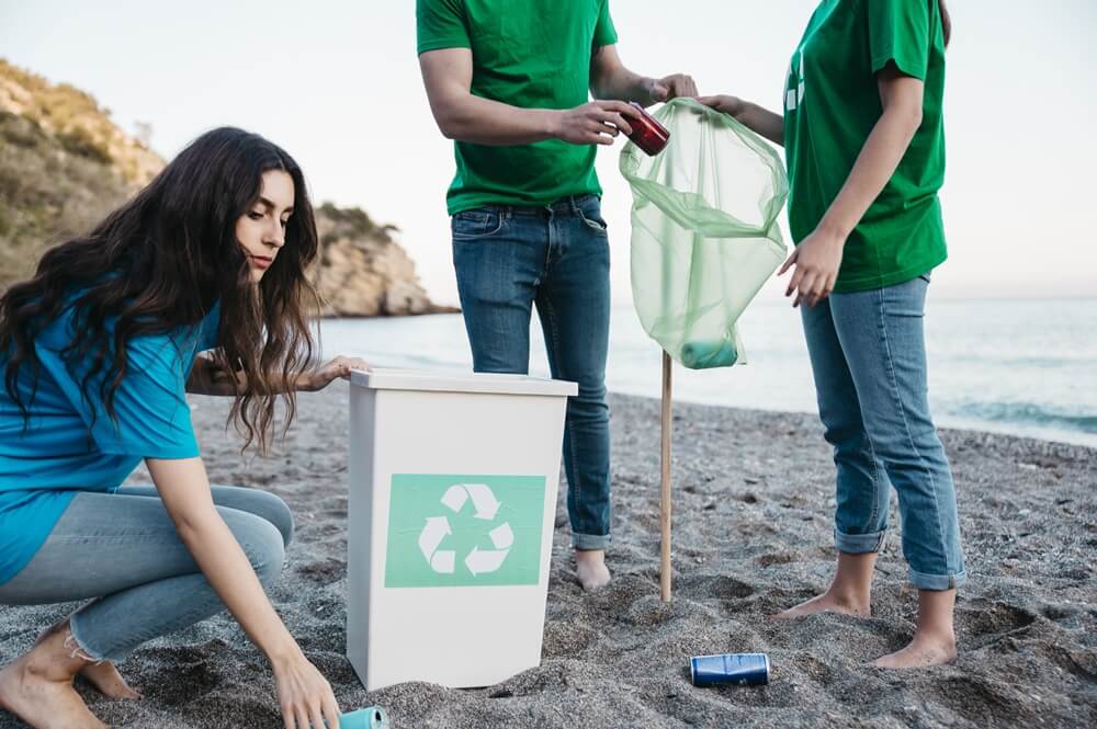 Three young volunteers implement the three principles of reduce, reuse and recycle into their daily lives to contribute to a more sustainable future for our planet