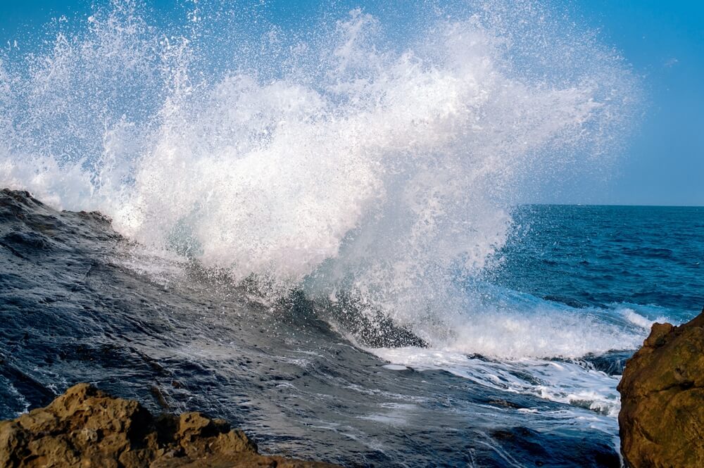 Stunning shot of a powerful sea waves crashing rock