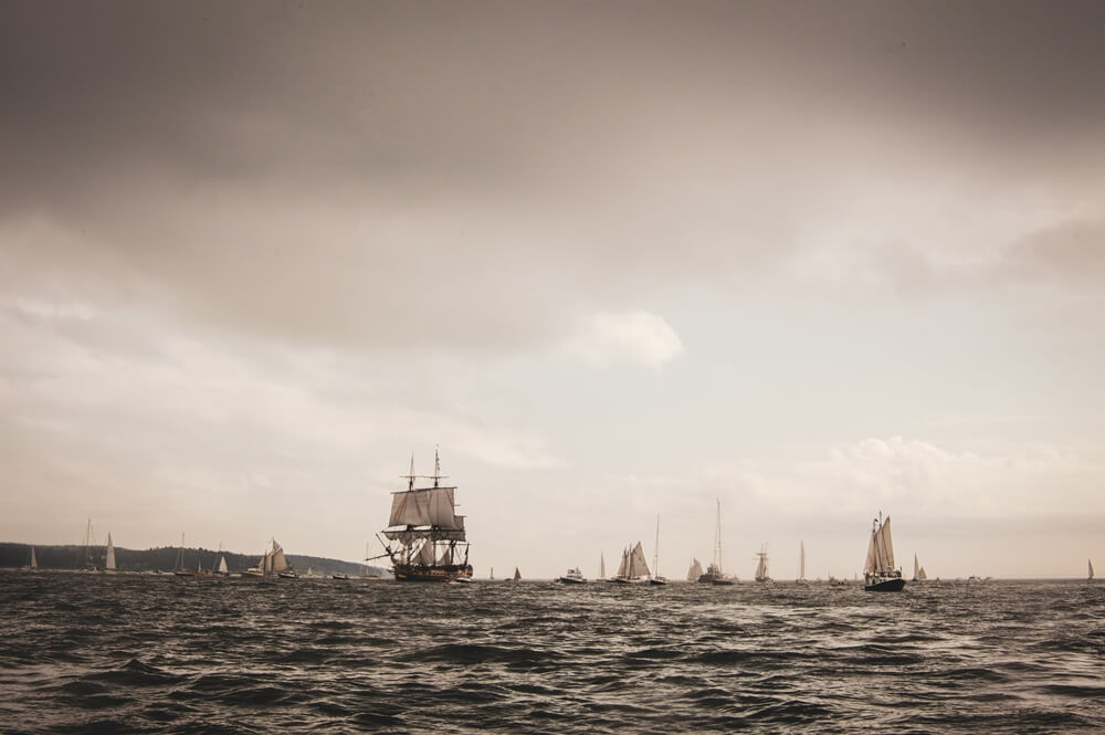 Landscape sea with sailing ships in a cloudy sky evening