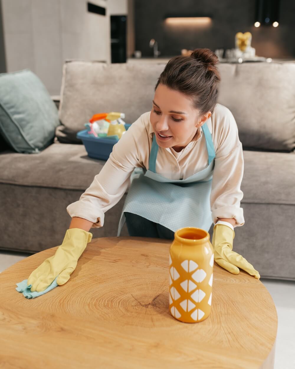 Women cleaning the room table surfaces using sustainable cleaning practices