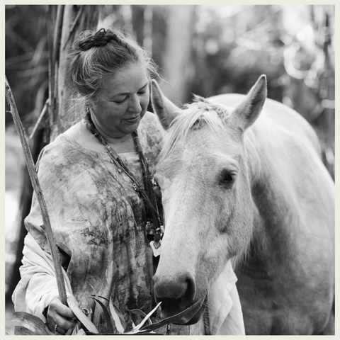 India Flint - woman standing next to horse