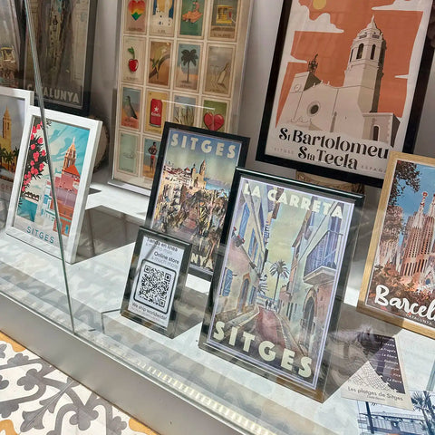 posters and postcards of Sitges and Barcelona in the window of la Galerie by Myretroposter