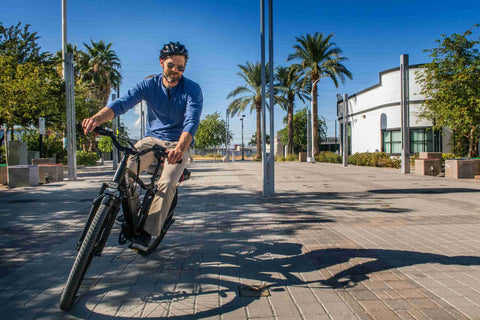 guy riding an electric bike, riding an electric bike on pavement