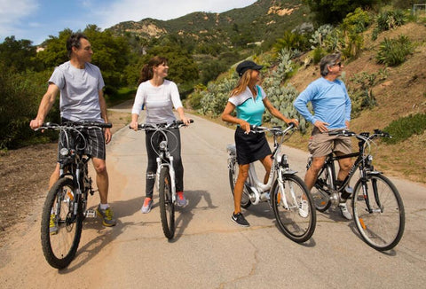 Group of people riding electric bikes on a sunny day
