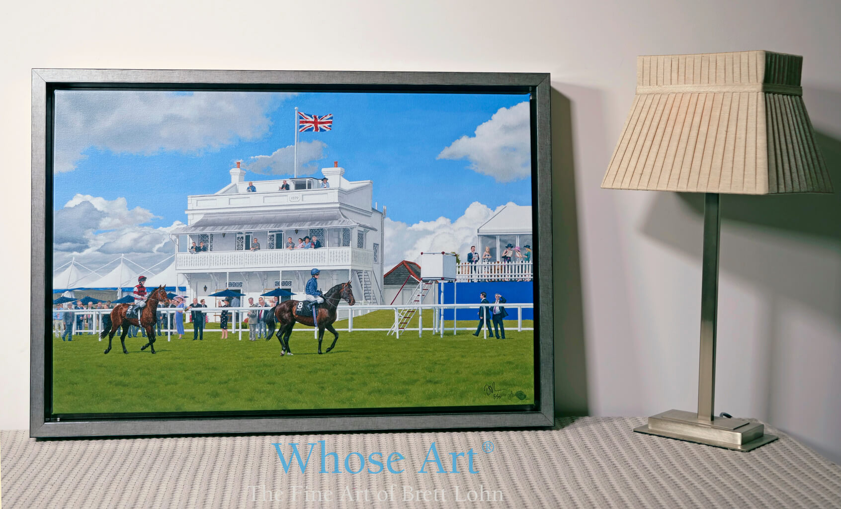 Framed painting of a Coronation Cup. horse racing art leaning on a table by a lamp