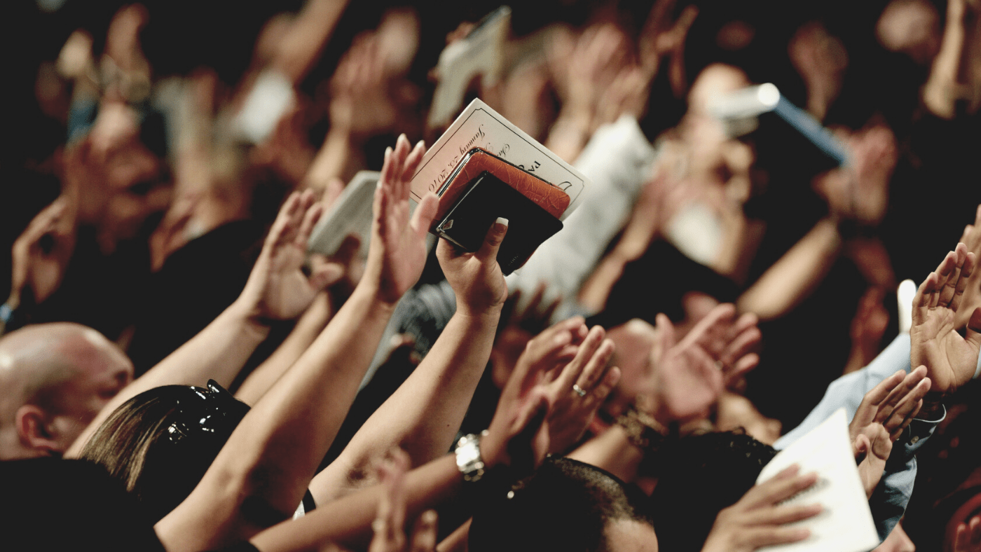 people raising hands in worship