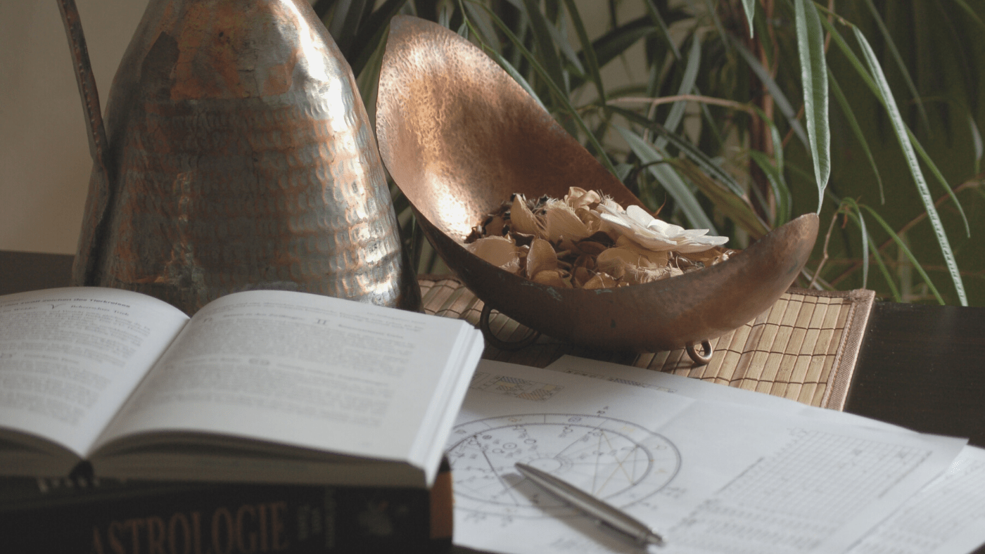 image of books astrology and herbs in bowl