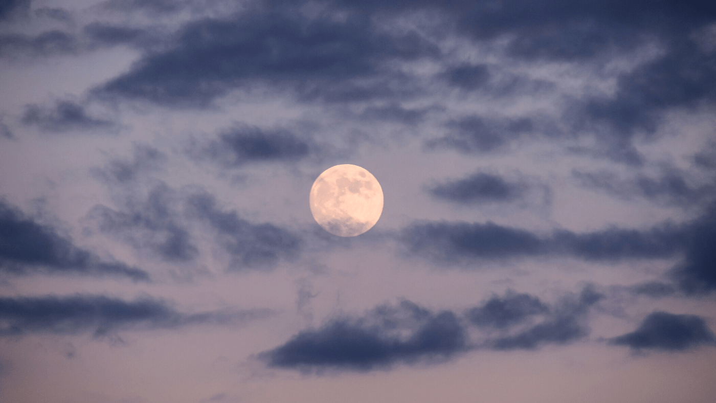 full moon in blue sky signifying the moon cycles