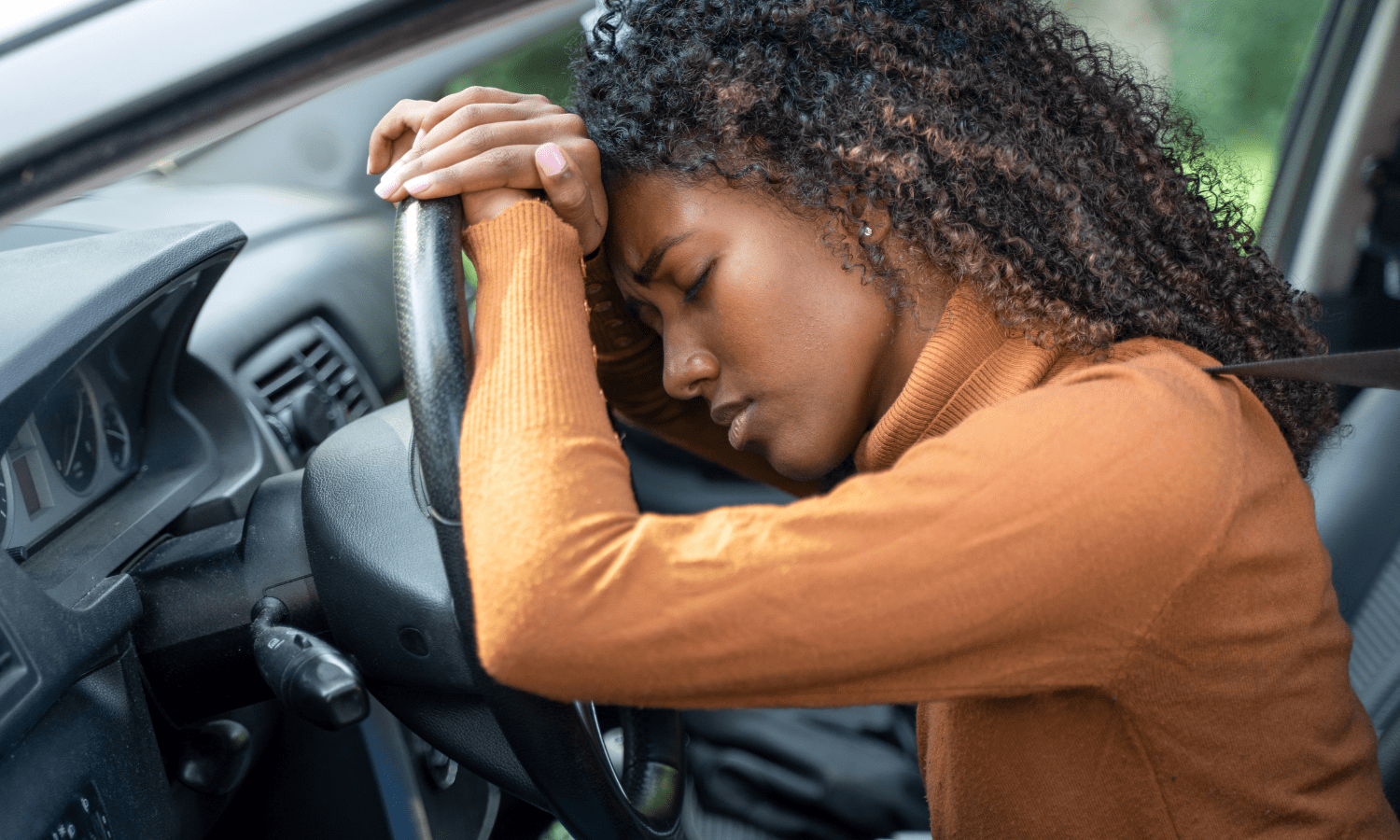 women in car looking stressed
