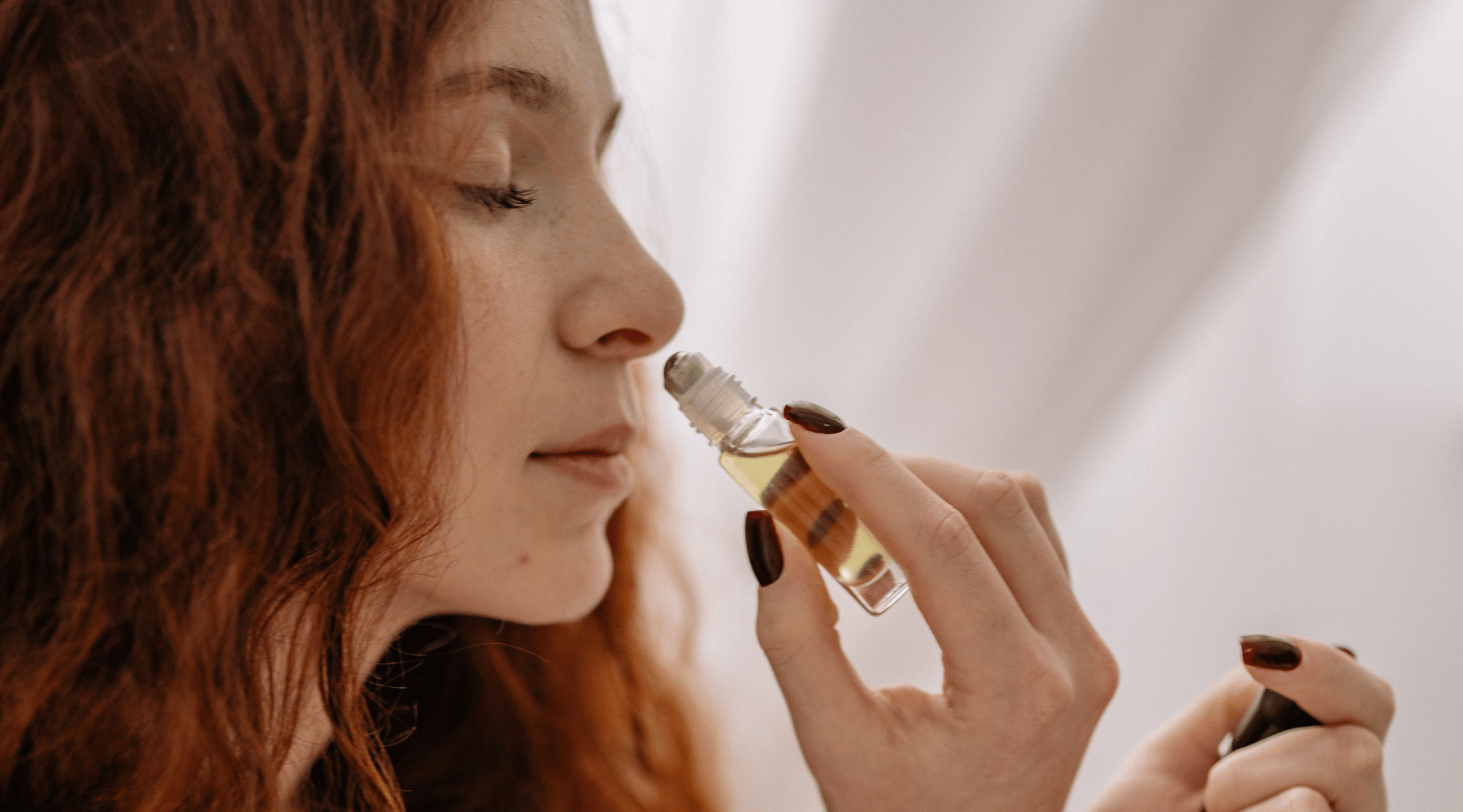 women smelling essential oil