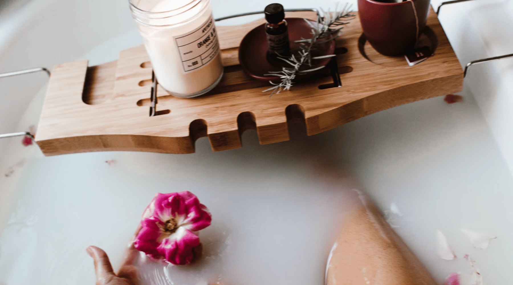 woman in bathtub surrounded by aromatherapy
