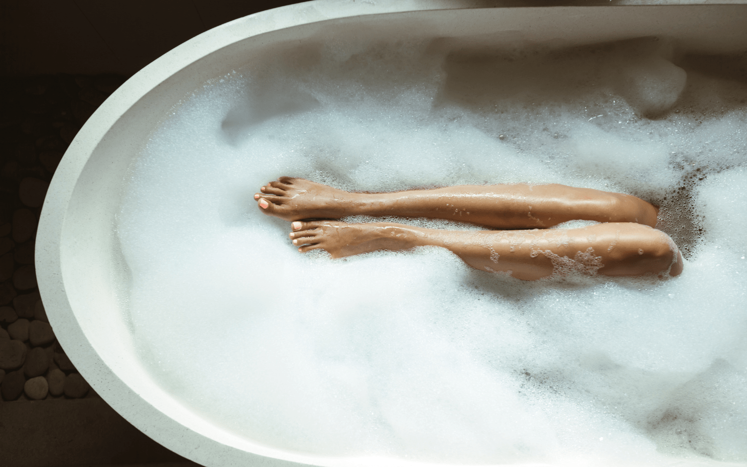 womens legs in bubble bath