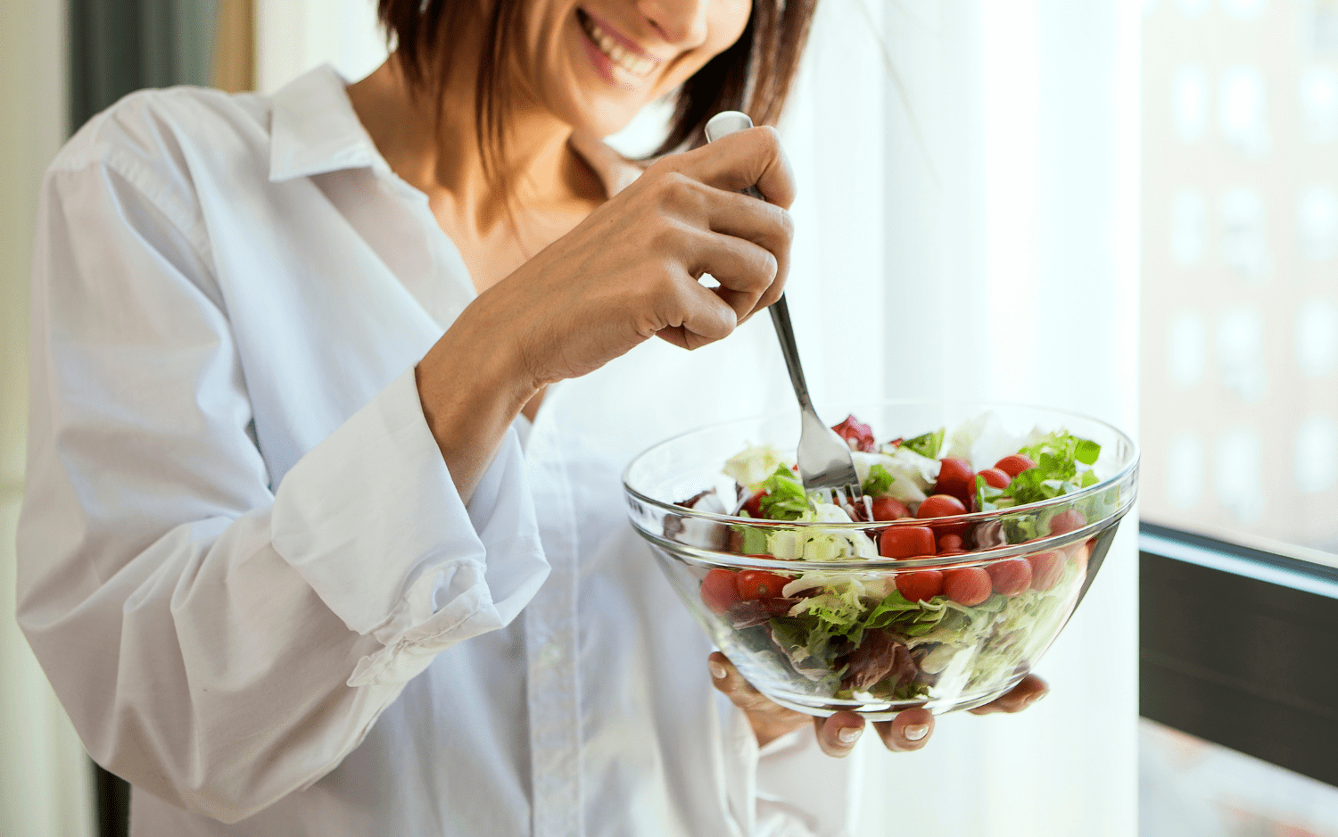 women eating a bowl of salad 