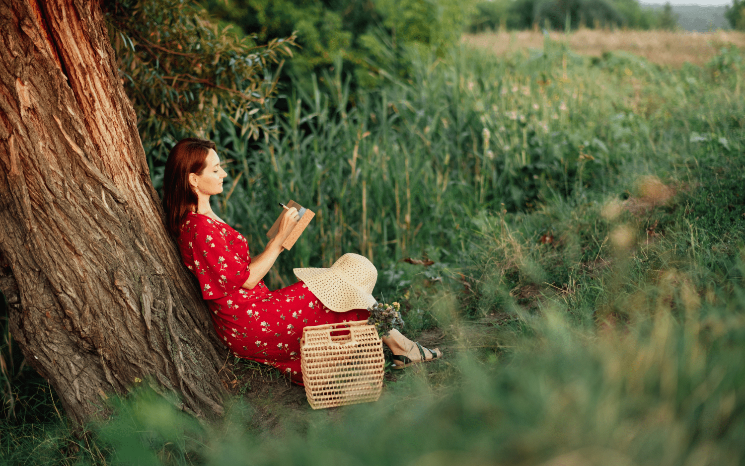 women reading by a tree