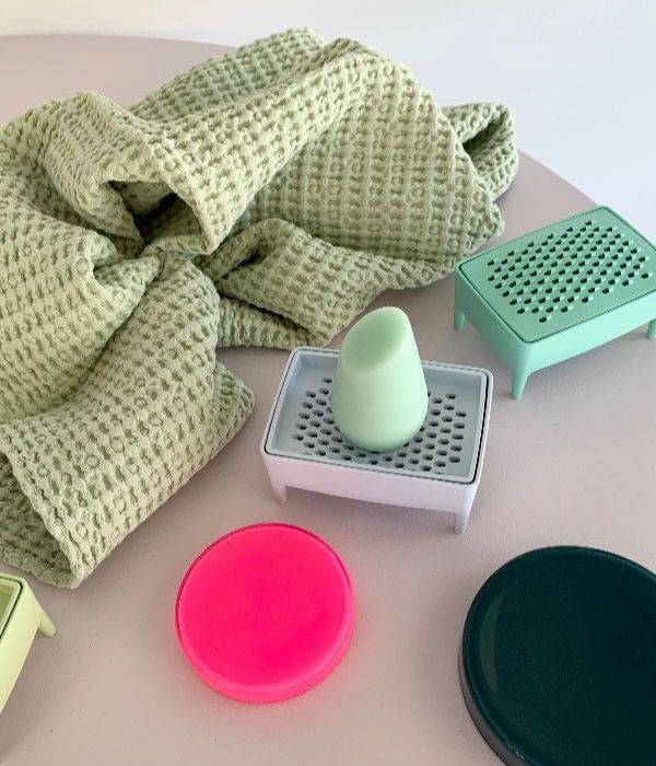 a waffle texture towel next to a soap dish and some little containers