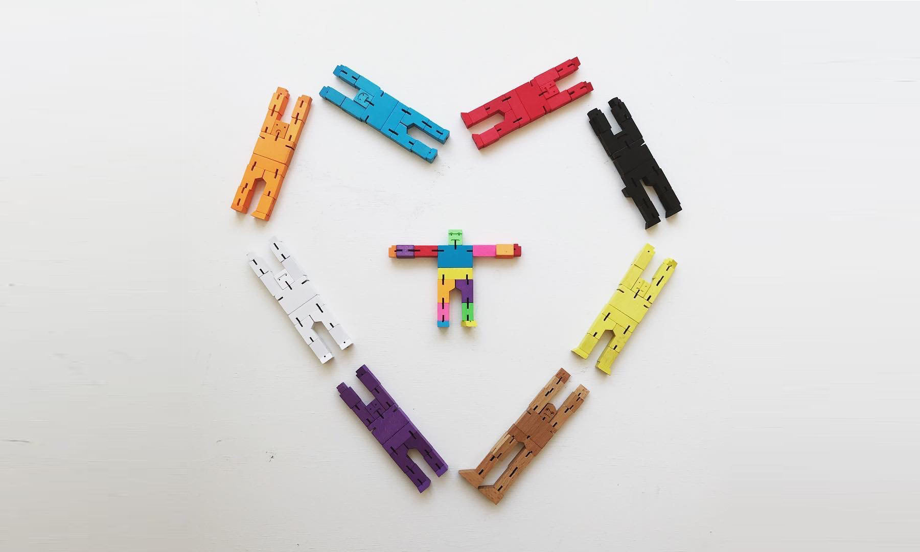 different colored robot toys arranged in a heart